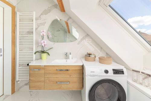 a bathroom with a washing machine and a sink at Apartma pri Jakobu in Postojna