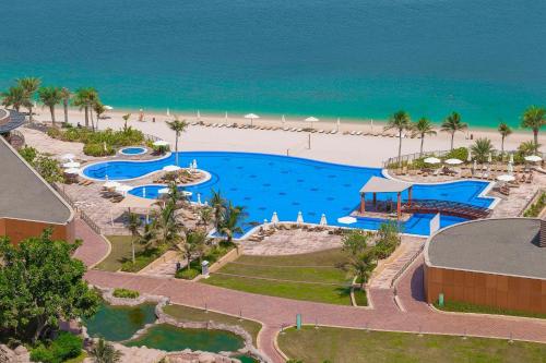 an aerial view of a resort with a pool and the beach at Andaz by Hyatt – Palm Jumeirah in Dubai