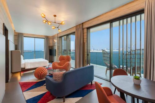 a living room with a view of the ocean at Hyatt Centric Jumeirah Dubai in Dubai