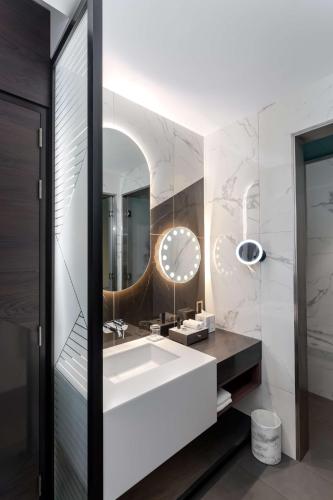 a bathroom with a white sink and a mirror at Hyatt Centric Jumeirah Dubai in Dubai
