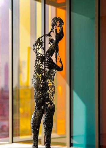 a statue of a woman standing in front of a window at Hyatt Centric Jumeirah Dubai in Dubai