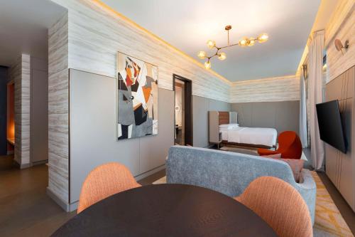 a living room with a table and chairs and a bed at Hyatt Centric Jumeirah Dubai in Dubai