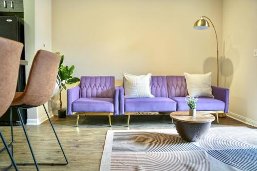 a purple couch in a living room with a table at Los Angeles Modern Studio in Los Angeles