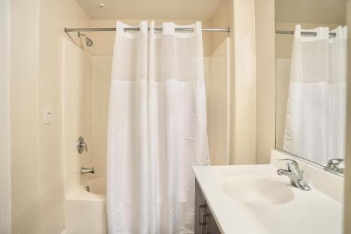 a bathroom with a shower curtain and a sink at Los Angeles Modern Studio in Los Angeles