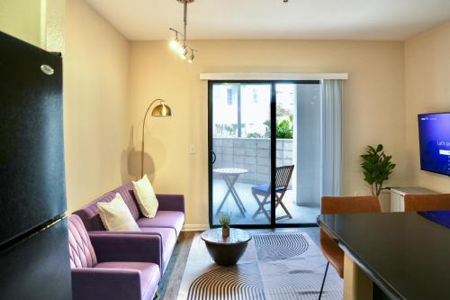 a living room with a couch and a tv at Los Angeles Modern Studio in Los Angeles