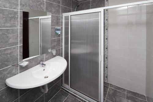 a bathroom with a sink and a shower at Yavor Palace Hotel - All Inclusive in Sunny Beach