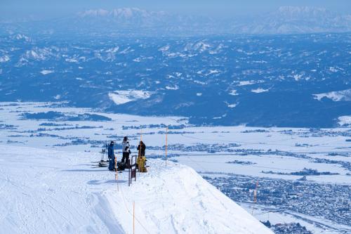 a group of people standing on top of a snow covered mountain at Lotte Arai Resort in Myoko