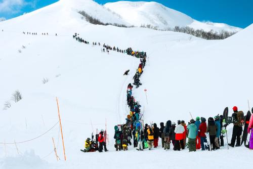 a group of people standing on a snow covered mountain at Lotte Arai Resort in Myoko