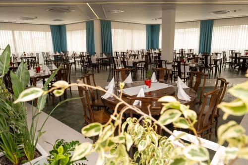 an empty banquet hall with tables and chairs and plants at Holiday Village Türkiye in Dalaman