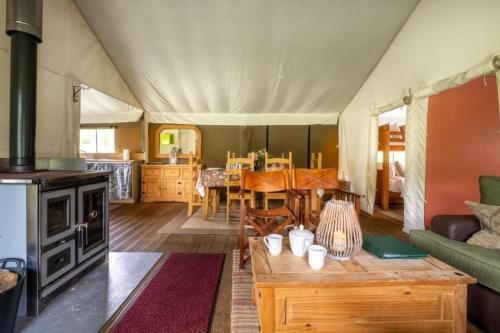 a living room with a tent with a couch and a table at Coot - Exton Park in Exton