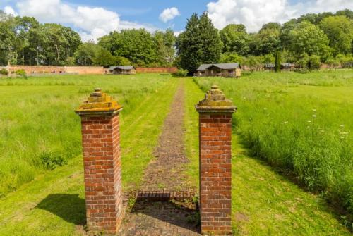 two brick posts in the middle of a field at Coot - Exton Park in Exton