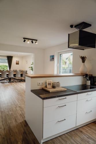 a kitchen with white cabinets and a counter top at Traumfabrik Eifel mit Sauna & Whirlpool in Monschau