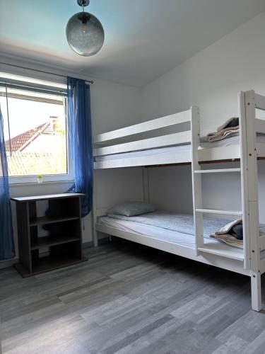 a bedroom with two bunk beds and a window at Cozy Apartment next Outlet Center & Airport with Pool & Garden in Parndorf