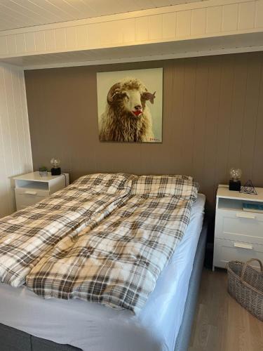 a bedroom with a bed with a picture of a sheep at Voss Resort self-service apartments in Skulestadmo