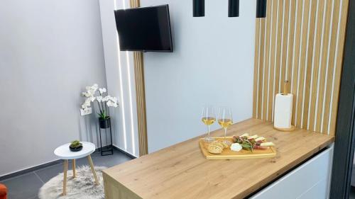 een tafel met een dienblad met eten en wijnglazen bij Apartments Cintya in Poreč