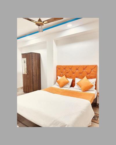 a bedroom with two beds and a ceiling fan at Yash-Deep - 100 meter Calangute Beach in Calangute