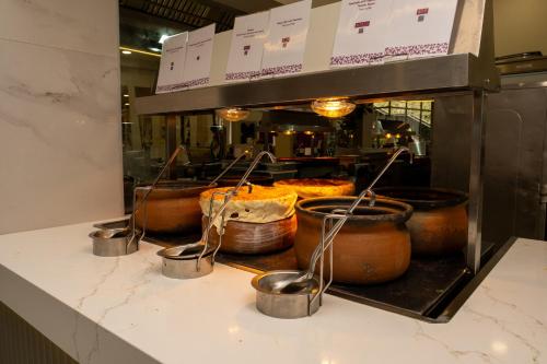 a kitchen with several pots of food on a counter at Holiday Village Türkiye in Dalaman