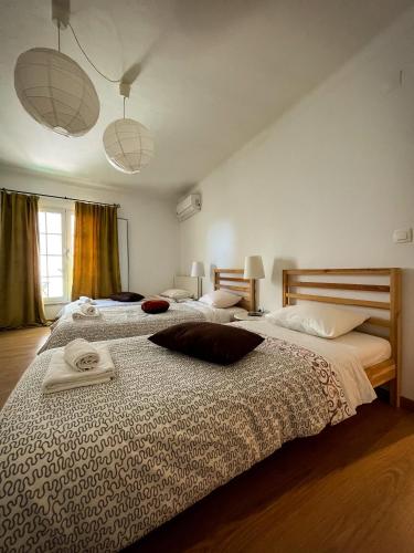 a bedroom with two beds with towels on the bed at Casa da Fonte Grande - By Cabralina Apartments in Belmonte