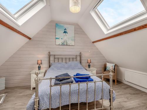 A bed or beds in a room at High Tide House