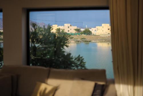 a window with a view of a body of water at SS resorts in Hatta