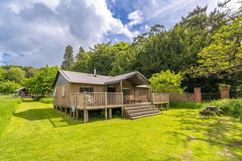 a tiny house in a yard with a deck at Osprey - Exton Park in Exton