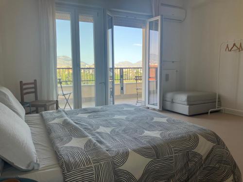1 dormitorio con 1 cama y vistas a un balcón en CasaMare Sant'Erasmo Apartment, en Palermo