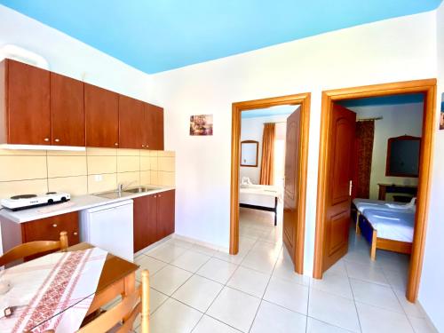 a kitchen with a sink and a table at Villa Marianna in Parga