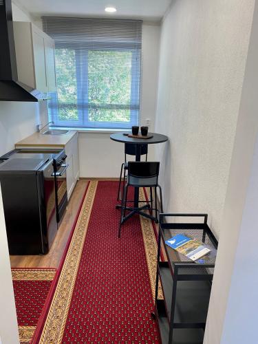 a small kitchen with a table and a stool at Karula Stay 1-Room Apartment in Antsla