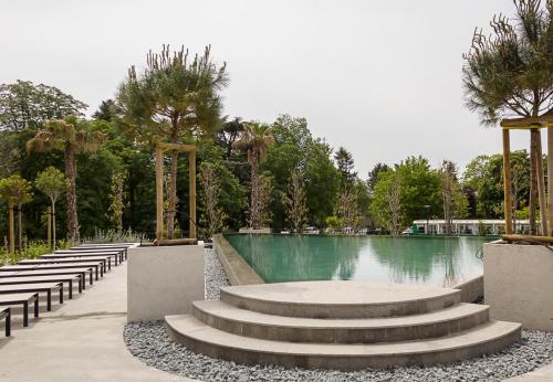 a swimming pool with stairs and trees in a park at Azur Delux -1BD Flat with Parking & Pool by Flat Mаnаger in St. St. Constantine and Helena