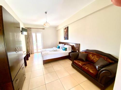 a living room with a bed and a couch at Villa Marianna in Parga