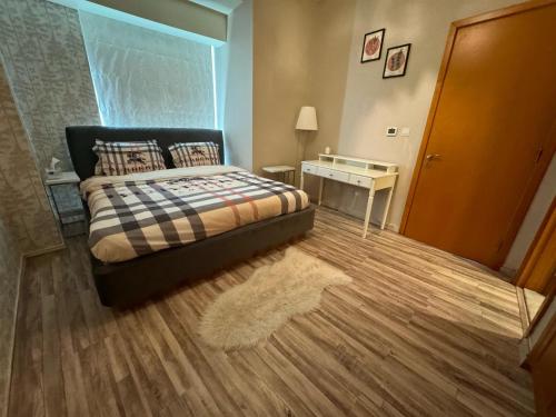 a bedroom with a bed and a table and a window at 2 Bedroom & 3 Bath Apartment in Dubai Marina - walking distance to JBR!" in Dubai