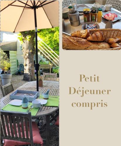 ein Tisch mit Sonnenschirm und ein Tisch mit Brot in der Unterkunft La Maison du Château in Chinon