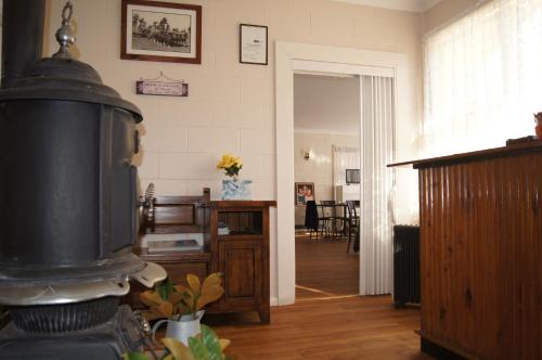 a living room with a stove in the middle of a room at ALPINE COUNTRY MOTEL and METRO ROADHOUSE COOMA in Cooma