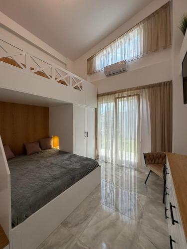 a bedroom with a bed and a large window at Milena's Luxury Villa in Iraklitsa