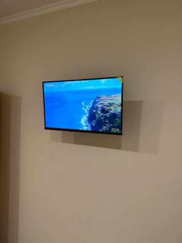 a flat screen tv hanging on a wall at Chambre LUXE in Quimper