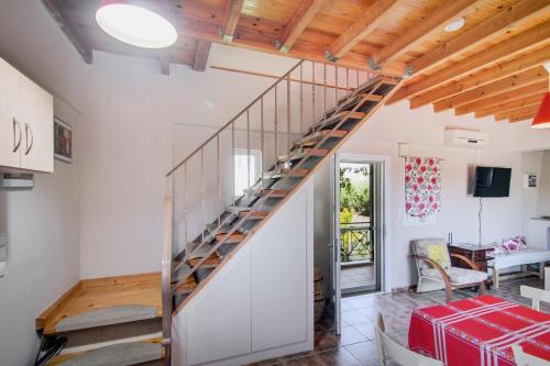 a staircase in a house with a living room at Villa Sotiria in Néa Thésis