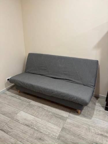 a couch sitting in a corner of a room at Chambre LUXE in Quimper