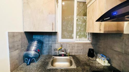 a kitchen counter with a sink and a tap at Residential Apartment Complex El-cilo B 414 in Islamabad