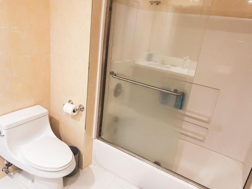 a bathroom with a shower and a toilet and a sink at House Downtown OC Santa Ana in Santa Ana