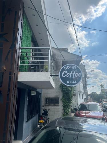 a sign for a motel coffee restaurant next to a building at Hotel Coffee Real Pereira in Pereira