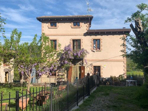 une maison avec une clôture devant elle dans l'établissement Casa del Sole Borgo Prediera, 