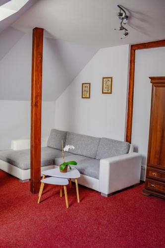 a living room with a couch and a table at Hotel Růžek in Hranice