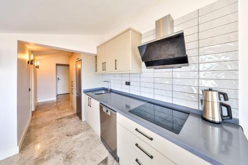 a kitchen with white cabinets and a counter top at Sole Vista Homes in Kas