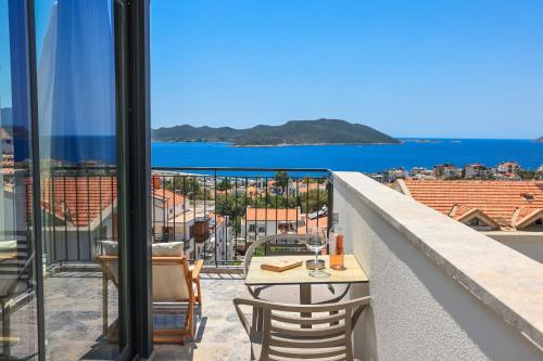 a balcony with a table and chairs and the ocean at Sole Vista Homes in Kas