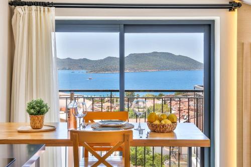 a dining room table with a view of the ocean at Sole Vista Homes in Kas