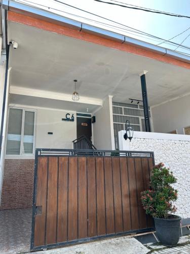 a wooden gate in front of a house at Clamitan House in Padalarang