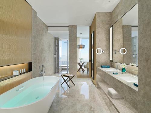 a bathroom with two sinks and a tub at Mandarin Oriental, Shenzhen in Shenzhen