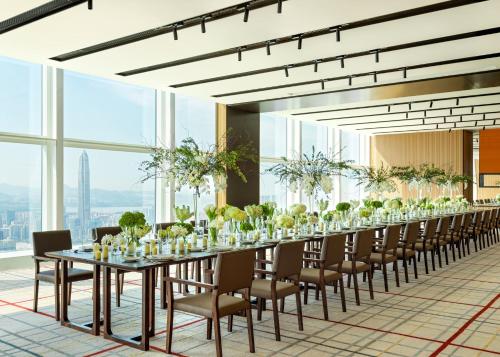 a long dining room with a long table and chairs at Mandarin Oriental, Shenzhen in Shenzhen