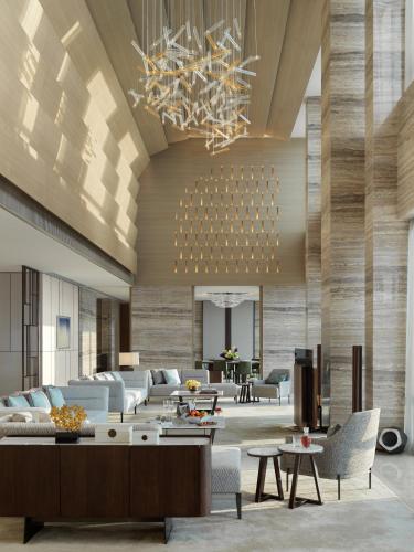 a lobby with couches and tables and a chandelier at Mandarin Oriental, Shenzhen in Shenzhen