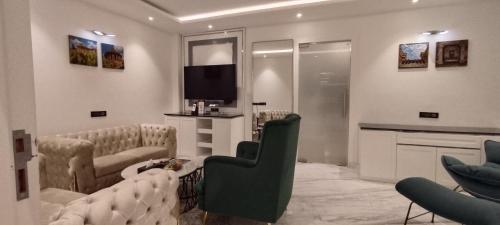 a living room with a couch and a television at Amanora The Fern Hotels & Club in Pune